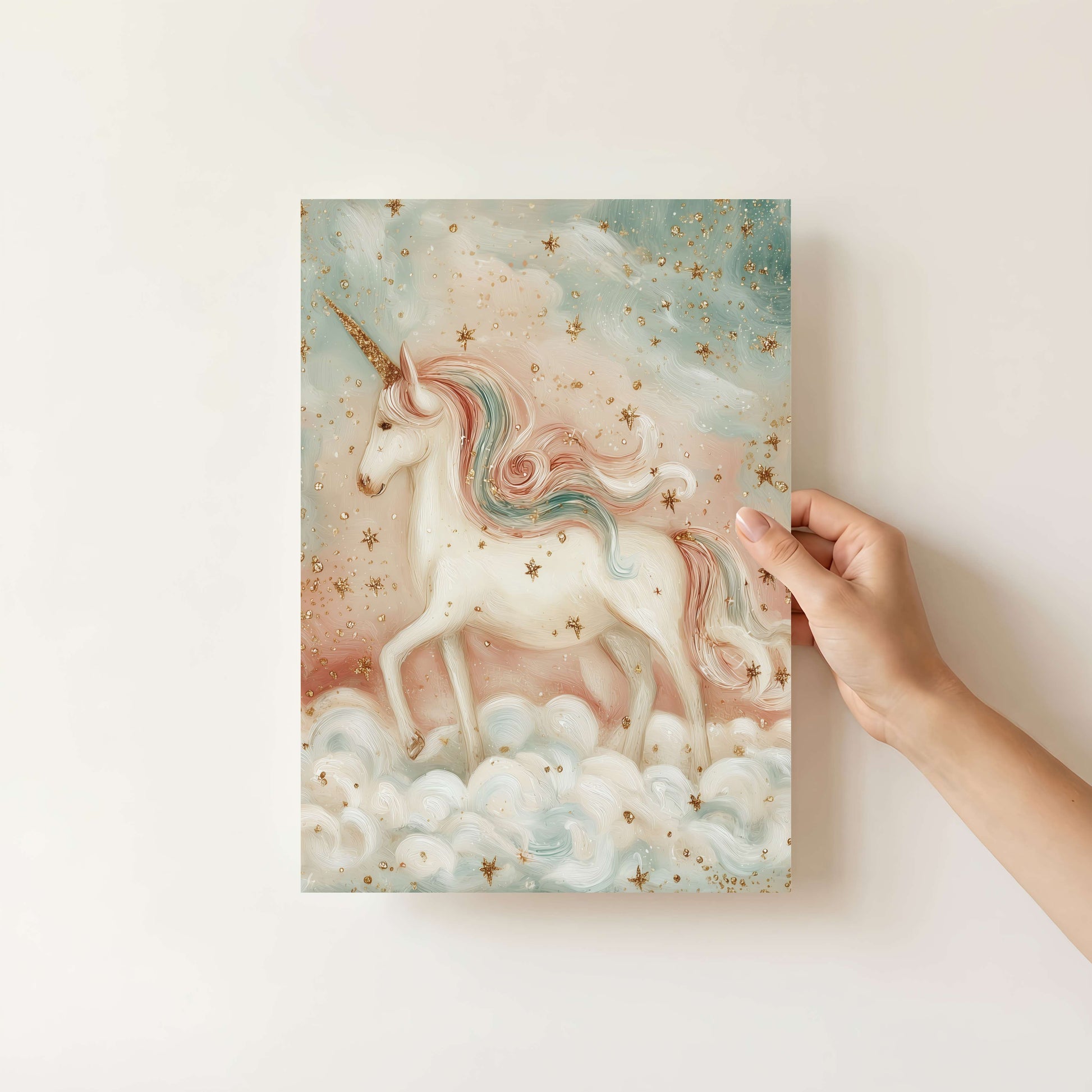 Hand holding a canvas print of a unicorn in a cloud with a pastel color palette.