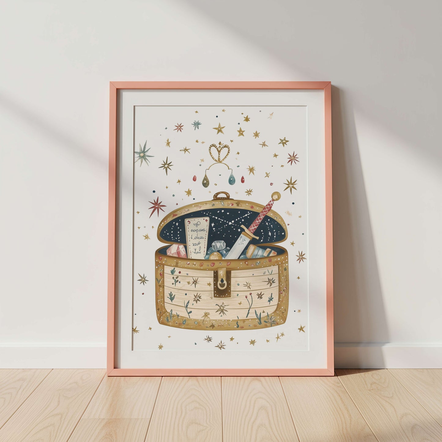 Framed artwork of a fairytale treasure chest with stars and a sword on a white wall.