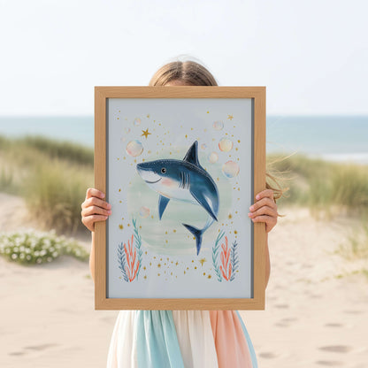 Person holding a framed artwork of a shark on a beach