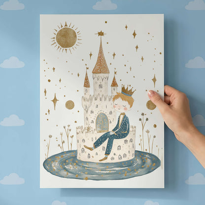 Hand holding a children's poster with a castle and prince design against a blue wall with cloud patterns.