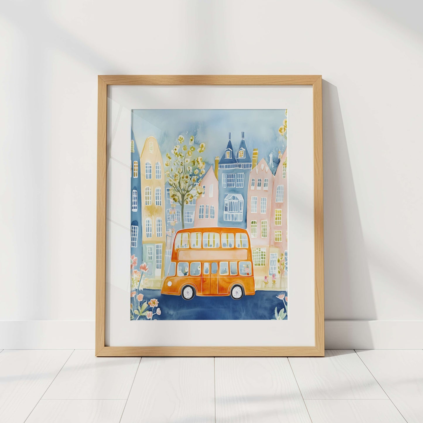 Framed artwork of a London cityscape with a double-decker bus on a white wall.