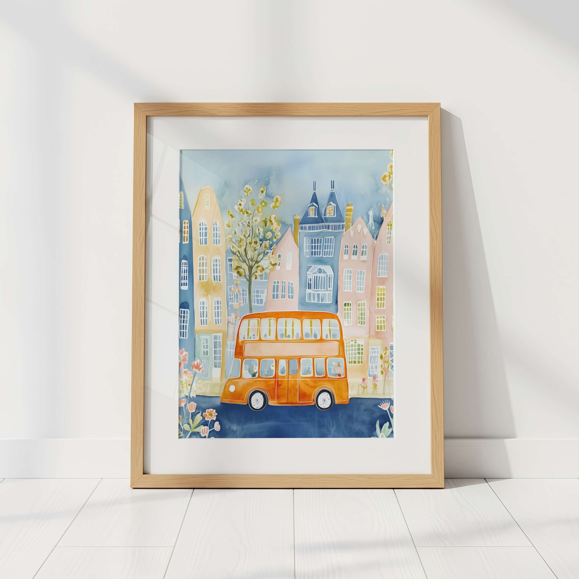 Framed artwork of a London cityscape with a double-decker bus on a white wall.