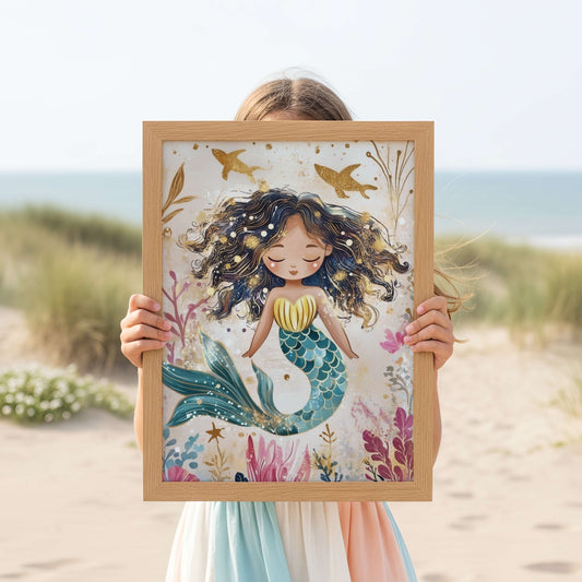 Person on a beach holding a framed illustration of a mermaid