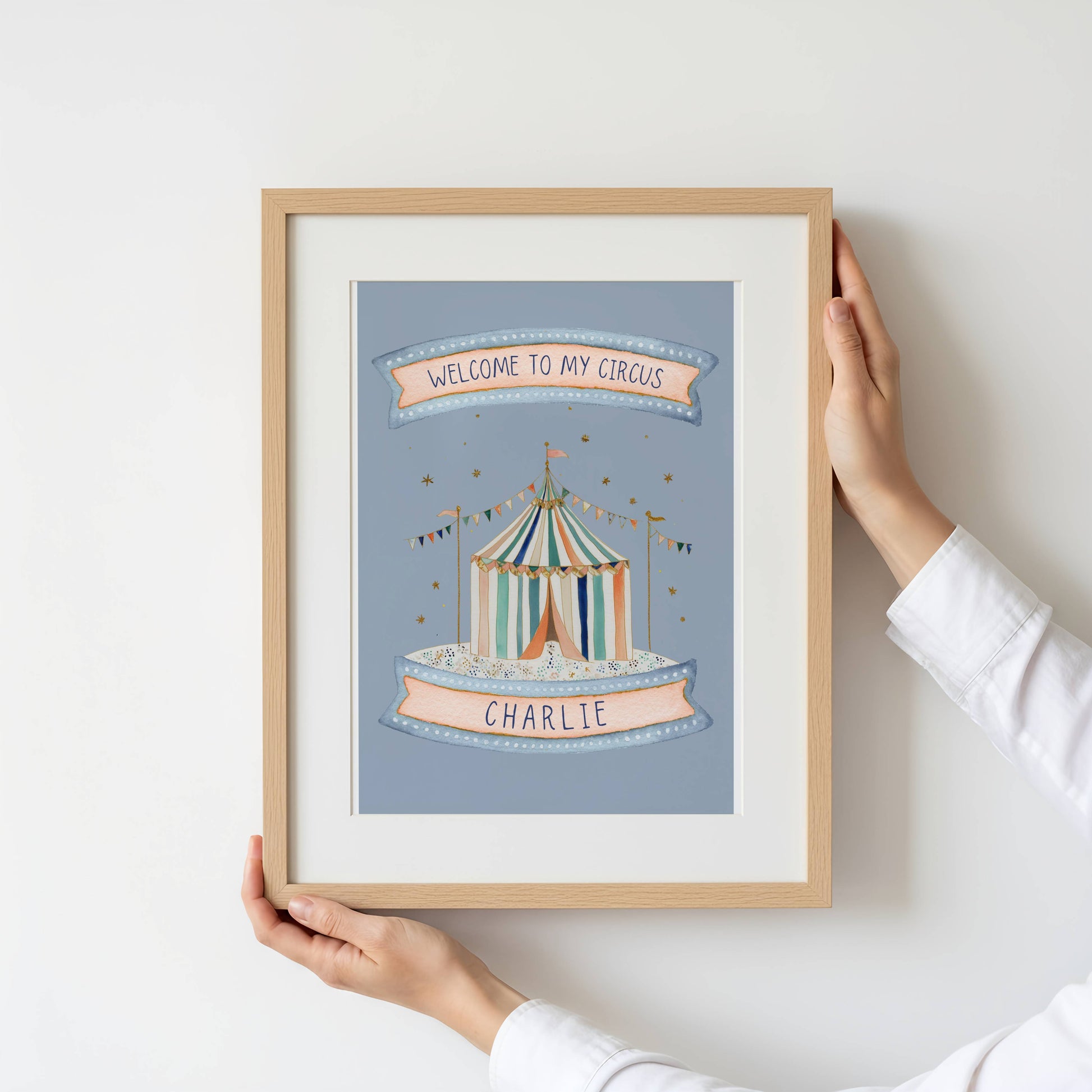 Framed artwork with a circus tent design and 'Welcome to my circus' text on a light blue background.