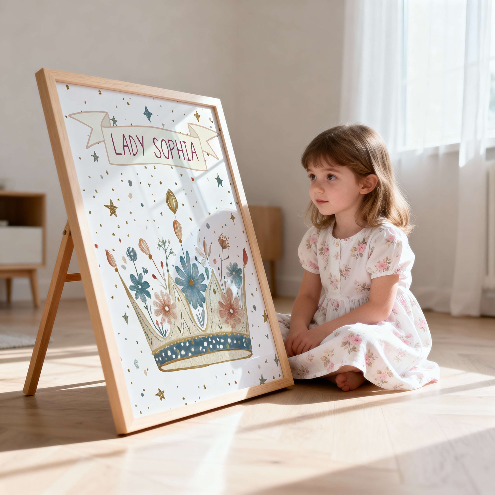 Young girl in a floral dress sitting next to a framed illustration of a crown with 'Lady Sophia' text.
