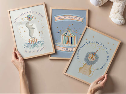Three framed children's posters on a beige surface with a teddy bear in the background.