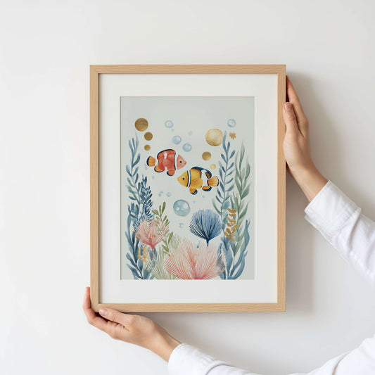 Framed artwork of underwater scene with fish and plants held by a person.