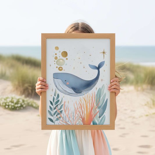 Person holding a framed illustration of a whale in an under the sea theme