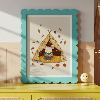Framed children's illustration of a mouse reading a book in a tent with autumn leaves, on a yellow surface.
